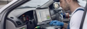 ECU Coding and Programming Birmingham – auto electrician programming an ECU with a laptop for Birmingham Auto Electrics.